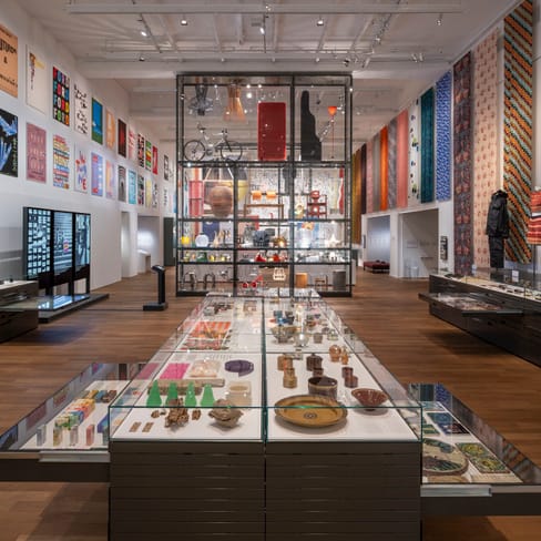 Innenansicht eines modernen Museums mit Exponaten und Wandkunst.