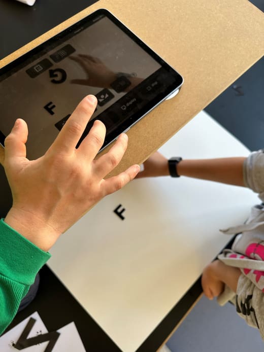 Eine Person scannt einen Buchstaben mit einem Tablet.